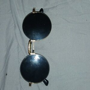 Circular sunglasses with gold frames. Unbranded.